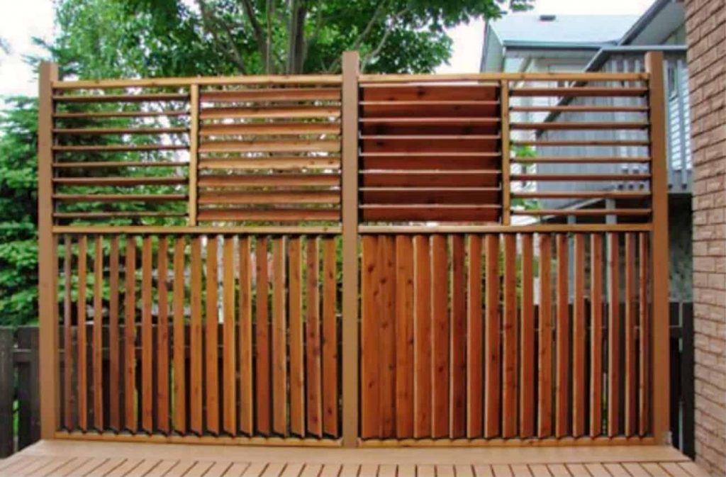 A stunning louvered privacy fence with louvers built in sections, allowing them to be positioned both vertically and horizontally.